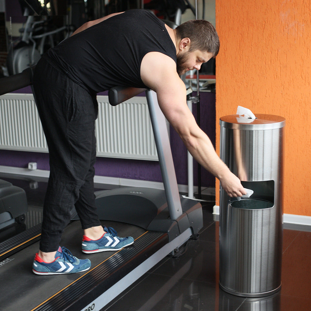 gym wipe dispenser with trash can - on treadmill in gym